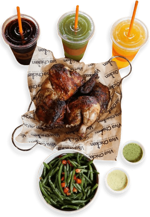 A platter with roasted chicken halves on branded paper, a bowl of green beans with diced carrots, two small cups of green sauce, and three colorful drinks with orange straws.